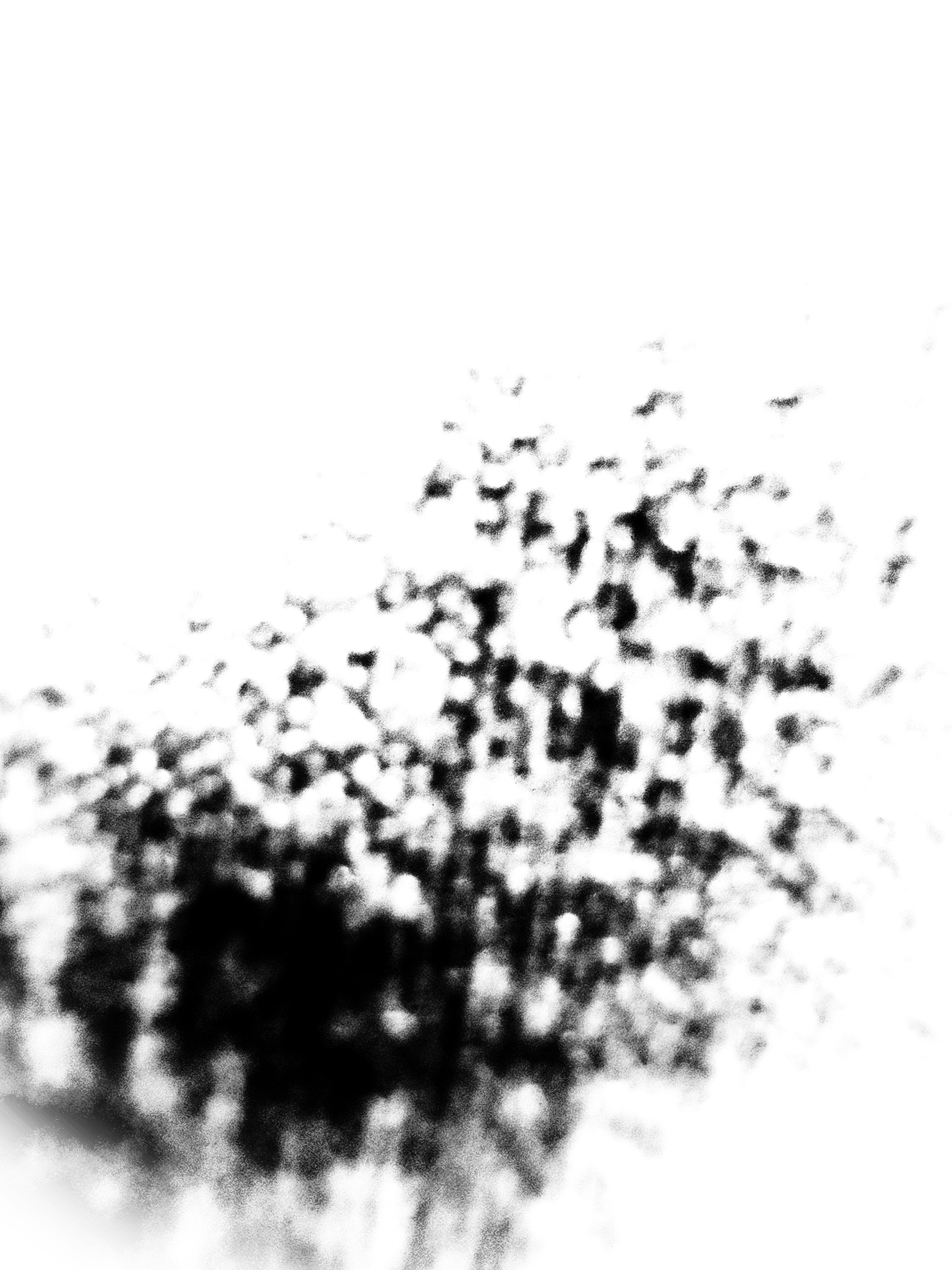 abstract image with blurry dots and smudges at the bottom left-hand corner